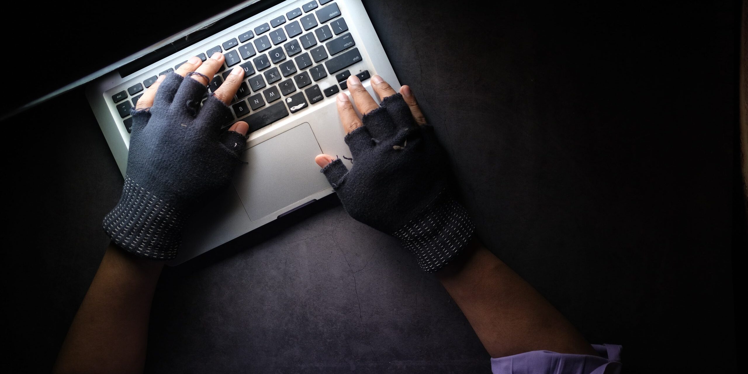 person in black long sleeve shirt using macbook pro